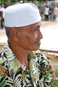 PROUD ONLOOKER: Mr. Alin, owner of the sure-footed Kompang Jaya, watches the buffalo races. (Wes Lafortune)
