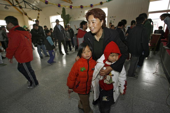 Frau Zhang Shuqin kündigte ihren Job als Krankenschwester und gründete 1996 ihr erstes Kinderheim am Stadtrand von Peking. Das Sonnendorf. Anfangs wurde sie für ihr Engagement noch auf offener Straße beschimpft. Niemand fühlte sich verantwortlich für die hinterbliebenen Kinder. Mittlerweile toleriert der Staat die Einrichtung.
