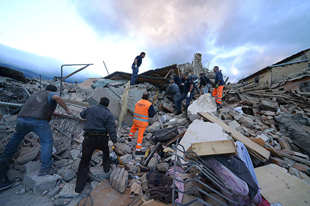 Resucers search for victims in damaged buildings after a strong heartquake hit Amatrice on August 24, 2016. Central Italy was struck by a powerful, 6.2-magnitude earthquake in the early hours, which has killed at least three people and devastated dozens of mountain villages. Numerous buildings had collapsed in communities close to the epicenter of the quake near the town of Norcia in the region of Umbria, witnesses told Italian media, with an increase in the death toll highly likely. / AFP / FILIPPO MONTEFORTE (Photo credit should read FILIPPO MONTEFORTE/AFP/Getty Images)