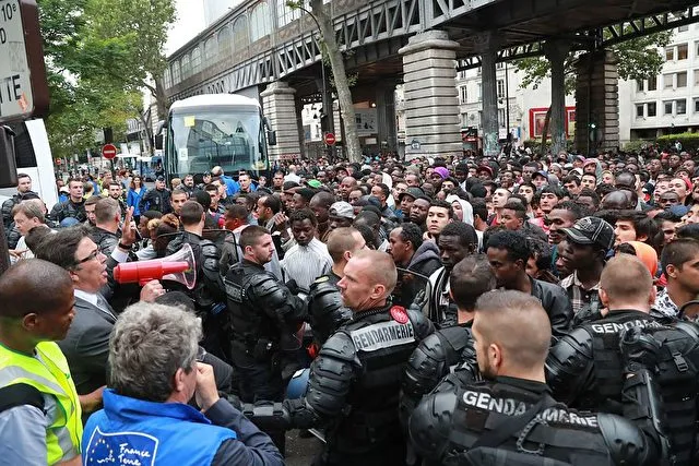 Migrants are evicted from a makeshift camp by French gendarmes, on July 22, 2016 in Paris. Between 1,200 and 1,400 people, mostly men, from Eritrea, Somalia and Afghanistan, were in this camp near the metro stations Jaures and Colonel Fabien. / AFP / JACQUES DEMARTHON (Photo credit should read JACQUES DEMARTHON/AFP/Getty Images)