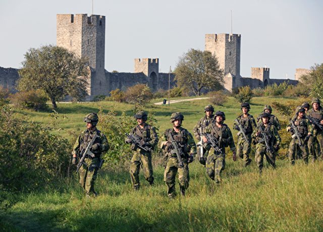A squad from Skaraborg Armoured Regiment patrol outside Visby's 13th century city wall in Sweden on September 14, 2016. Sweden's Baltic Sea island of Gotland is once again home to a permanent military presence, the military said, amid speculation over the country's ability to defend itself against a more assertive Russia. / AFP / TT NEWS AGENCY AND TT News Agency / SOREN ANDERSSON / Sweden OUT (Photo credit should read SOREN ANDERSSON/AFP/Getty Images)