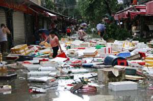 TOPSHOT - Residents clean up a flooded street in Xiamen, in China's eastern Fujian province after Typhoon Meranti made landfall on September 15, 2016. Parts of Taiwan came to a standstill on September 15 as super typhoon Meranti brought the strongest winds in 21 years, while China issued a red alert for waves as the storm bore down on the mainland. / AFP / STR / China OUT (Photo credit should read STR/AFP/Getty Images)