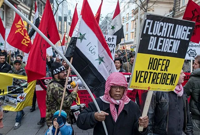 Austrian citizens and asylum seekers march during a pro-refugee protest called "Let them stay" in Vienna, Austria on November 26, 2016. Austria will hold the postponed second round of the presidential elections on December 4, 2016. / AFP / JOE KLAMAR (Photo credit should read JOE KLAMAR/AFP/Getty Images)