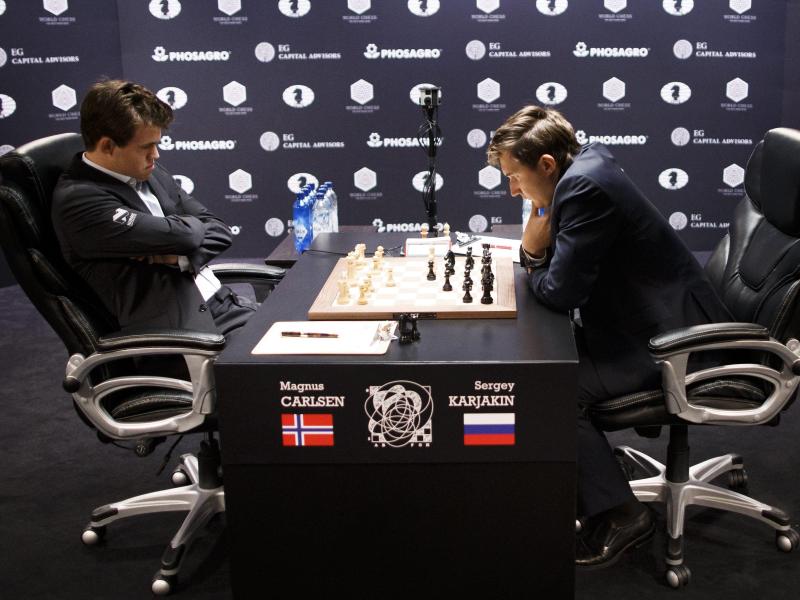 Magnus Carlsen (l) spielte die erste Partie der WM gegen Sergey Karjakin remis. Foto: Justin Lane/dpa