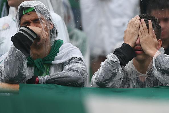 CHAPECO, BRAZIL - DECEMBER 03: Fans cry while paying tribute to the players of Brazilian team Chapecoense Real at the club's Arena Conda stadium in Chapeco, in the southern Brazilian state of Santa Catarina, on December 03, 2016. The players were killed in a plane accident in the Colombian mountains. Players of the Chapecoense team were among the 77 people on board the doomed flight that crashed into mountains in northwestern Colombia. Officials said just six people were thought to have survived, including three of the players. Chapecoense had risen from obscurity to make it to the Copa Sudamericana finals scheduled for Wednesday against Atletico Nacional of Colombia. (Photo by Buda Mendes/Getty Images)