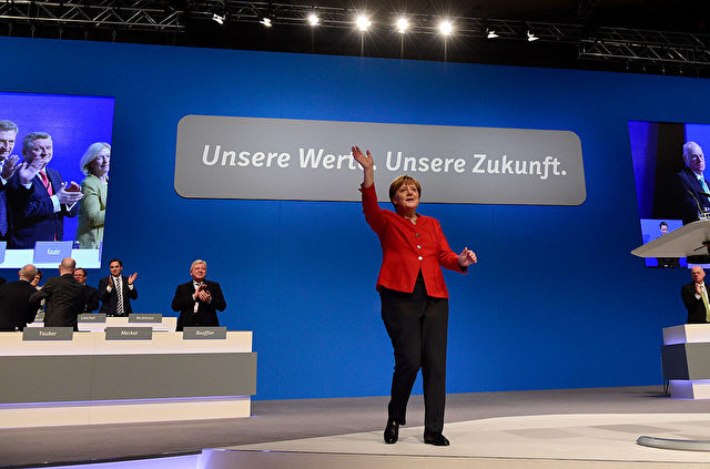 German Chancellor Angela Merkel gestures after addressing delegates during her conservative Christian Democratic Union (CDU) party's congress in Essen, western Germany, on December 6, 2016. German Chancellor Angela Merkel launches into campaign mode for elections taking place in 2017. / AFP / TOBIAS SCHWARZ (Photo credit should read TOBIAS SCHWARZ/AFP/Getty Images)
