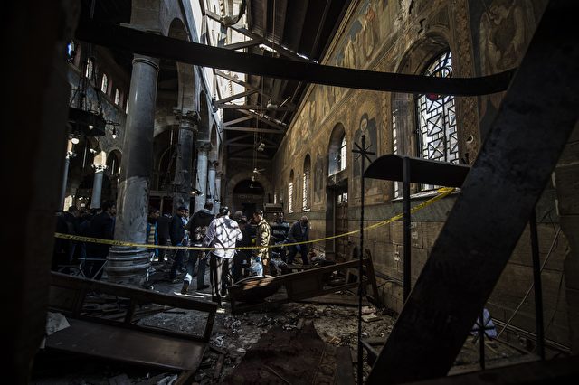 TOPSHOT - Egyptian security forces inspect the scene of a bomb explosion at the Saint Peter and Saint Paul Coptic Orthodox Church on December 11, 2016, in Cairo's Abbasiya neighbourhood. The blast killed at least 25 worshippers during Sunday mass inside the Cairo church near the seat of the Coptic pope who heads Egypt's Christian minority, state media said. / AFP / KHALED DESOUKI (Photo credit should read KHALED DESOUKI/AFP/Getty Images)