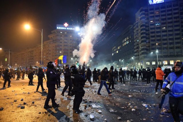 Romanian riot police fire tear gas to disperse people taking part in a protest against controversial decrees to pardon corrupt politicians and decriminalize other offenses in front of the government headquarters in Bucharest, on February 1, 2017. At least 200,000 people hit the streets across Romania on February 1, 2017 for anti-government protests, the largest since communism fell in 1989, media reports said. / AFP / DANIEL MIHAILESCU (Photo credit should read DANIEL MIHAILESCU/AFP/Getty Images)