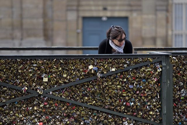 A woman looks at padlocks hanging on the "Pont des Arts" on May 29, 2015 in Paris as the Paris municipalty announced that the bridge fences have to be removed due to the weight of the padlocks put by tourists to ensure everlasting love. AFP PHOTO / CHARLY TRIBALLEAU (Photo credit should read CHARLY TRIBALLEAU/AFP/Getty Images)