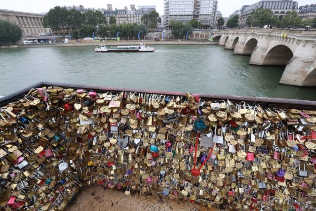 Love-locks are seen on the bridge of Pont Neuf in Paris, on August 4, 2016. Love may know no bounds, but Paris intends to instill some: authorities are going to take a tougher line with swooning couples attaching "love-locks" to city bridges as a sign of their undying devotion. In June last year authorities removed hundreds of thousands of such padlocks from the city bridges, notably the Pont des Arts which had a section collapse under the weight of the locks. / AFP / JACQUES DEMARTHON (Photo credit should read JACQUES DEMARTHON/AFP/Getty Images)