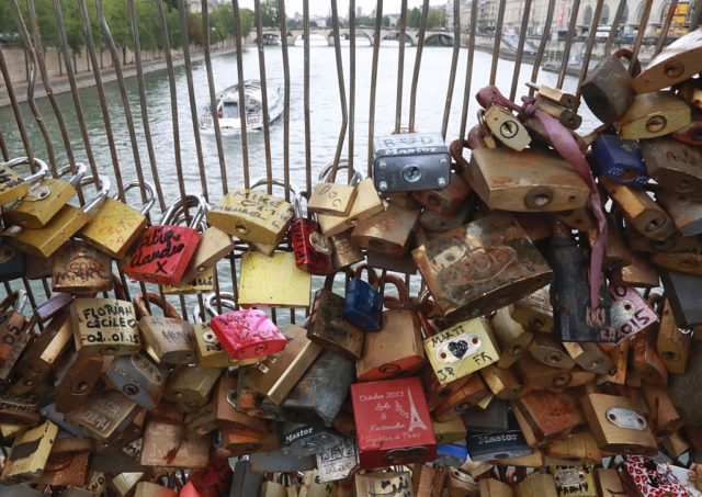 Love-locks are seen on the footbridge of Leopold-Sedar-Senghor in Paris, on August 4, 2016. Love may know no bounds, but Paris intends to instill some: authorities are going to take a tougher line with swooning couples attaching "love-locks" to city bridges as a sign of their undying devotion. In June last year authorities removed hundreds of thousands of such padlocks from the city bridges, notably the Pont des Arts which had a section collapse under the weight of the locks. / AFP / JACQUES DEMARTHON (Photo credit should read JACQUES DEMARTHON/AFP/Getty Images)