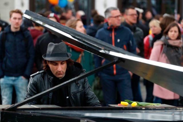 A demonstrator plays piano during a protest against the party congress of Germany's right-wing populist Alternative for Germany (AfD) in Cologne, western Germany, on April 22, 2017. The anti-immigration party, which hopes to win its first seats in the national parliament in a general election in September, will gather in the western city of Cologne on April 22-23, 2017. / AFP PHOTO / Odd ANDERSEN (Photo credit should read ODD ANDERSEN/AFP/Getty Images)