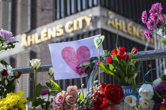 STOCKHOLM, SWEDEN - APRIL 09: Flowers are left on a fence outside of the Ahlens department store on April 9, 2017 in Stockholm, Sweden. An Uzbek man has been arrested, held on terrorism charges, following the attack which killed four people and injured another 15 when the hijacked truck crashed into the front of Ahlens department store. (Photo by Michael Campanella/Getty Images)