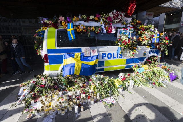 STOCKHOLM, SWEDEN - APRIL 09: Flowers are left on a police car to show their gratitude to law enforcement officers after a peace demonstration on Sergels square on April 9, 2017 in Stockholm, Sweden. An Uzbek man has been arrested, held on terrorism charges, following the attack which killed four people and injured another 15 when the hijacked truck crashed into the front of Ahlens department store. (Photo by Michael Campanella/Getty Images)