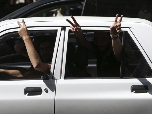 Anhänger des iranischen Präsidenten Ruhani zeigen Siegeszeichen aus ihrem Auto in Teheran. Foto: Vahid Salemi/dpa