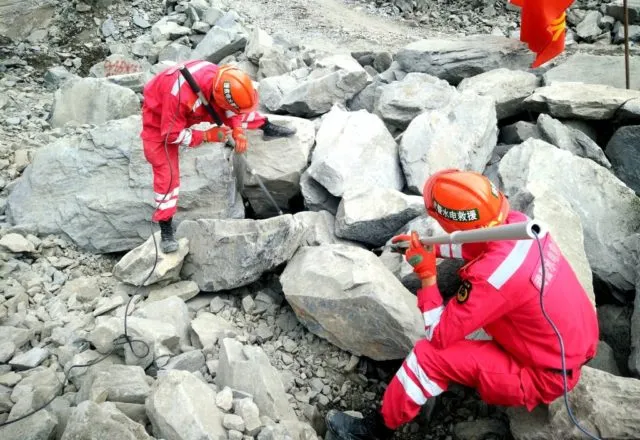 MAOXIAN, CHINA - JUNE 26: Rescuers search for survivors at the accident site after a landslide at Xinmo village on June 26, 2017 in Maoxian County, China. The landslide occurred early on Saturday, with more than 100 people still missing on Sunday morning. (Photo by VCG/Getty Images)
