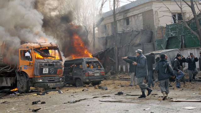 Afghan policemen gather at the site of a suicide attack in front of the German embassy in Kabul on January 17, 2009. A suicide bomb exploded near the German embassy in the Afghan capital, leaving people dead and wounded, the defence ministry said. The explosion -- in an area near UN offices and a US military base -- set alight a tanker and two vehicles, an AFP reporter at the scene said. AFP PHOTO/Massoud HOSSAINI (Photo credit should read MASSOUD HOSSAINI/AFP/Getty Images)