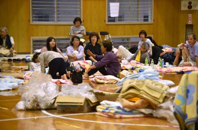 Evacuated residents from a flooded area stay at a school in Hita, Oita prefecture on July 6, 2017. At least two people have been killed and about 20 others are missing in huge floods that are surging through southern Japan, with hundreds of thousands of people ordered or urged to flee. / AFP PHOTO / KAZUHIRO NOGI (Photo credit should read KAZUHIRO NOGI/AFP/Getty Images)