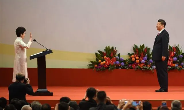 Hong Kong's new Chief Executive Carrie Lam (L) faces China's President Xi Jinping (R) as she is sworn in as the territory's new leader during a ceremony at the Hong Kong Convention and Exhibition Centre in Hong Kong on July 1, 2017. Lam became Hong Kong's new leader on July 1, which marks the culmination of the lifelong civil servant's career as she inherits a divided city fearful of China's encroaching influence. / AFP PHOTO / Anthony WALLACE        (Photo credit should read ANTHONY WALLACE/AFP/Getty Images)