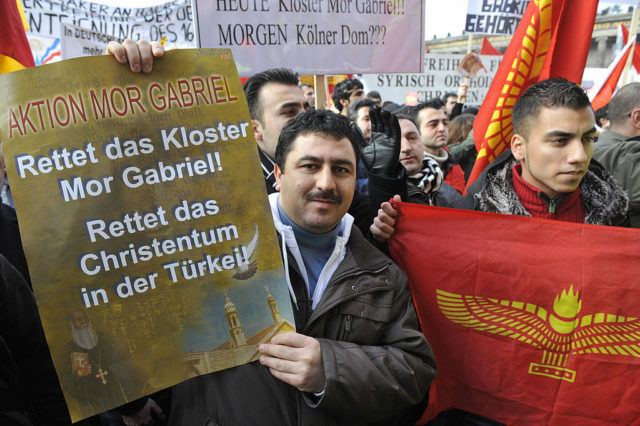 Members of the Syriac Orthodox church stage a demonstration outside Berlin's Cathedral (Berliner Dom) January 25, 2009. Thousands of Syriacs gathered to protest against the Turkish government's alleged mistreatment of the Syriac minority. They also claim the government is trying to expropriate the Syriac monastery of Mor Gabriel in Tur Abdin. AFP PHOTO JOHN MACDOUGALL (Photo credit should read JOHN MACDOUGALL/AFP/Getty Images)