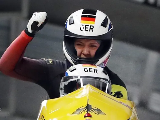 Pilotin Mariama Jamanka und Anschieberin Lisa Buckwitz jubeln nach dem Zieleinlauf über ihre Goldmedaille. Foto: Andy Wong/AP/dpa