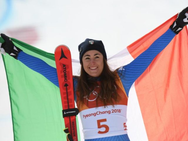 Siegerin Sofia Goggia jubelt mit der italienischen Nationalfahne. Foto: Tobias Hase/dpa