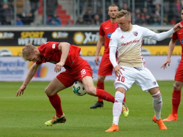 Heidenheims Sebastian Griesbeck (l) versucht gegen den Ingolstädter Sonny Kittel den Ball zu behaupten. Foto: Stefan Puchner/dpa
