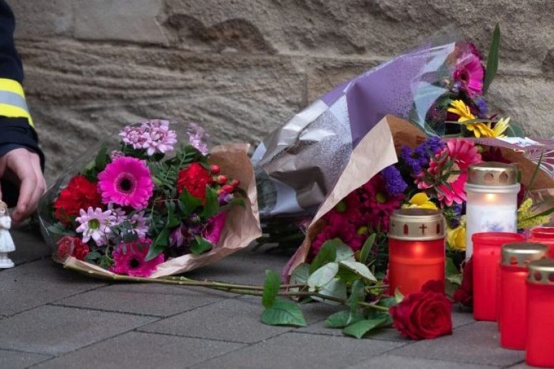 Eine Frau stellt vor der Polizeiinspektion Kusel einen Engel ab.
