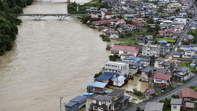 Der angeschwollenen Mogami-Fluss in Oe ist nach heftigen Regenfällen in der Präfektur Yamagata  in ein Wohngebiet am Flussufer übergetreten.
