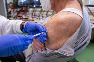 Ein Mann erhält in einem temporären mobilen Impfzentrum in Erlangen eine Auffrischungsimpfung gegen Covid-19.