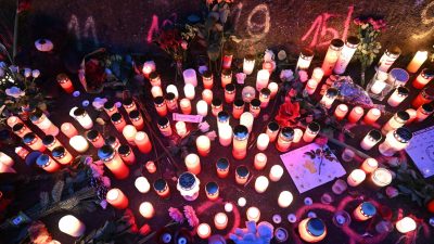 Kerzen und Blumen stehen an einem Tatort in Illerkirchberg, an dem am Tag zuvor zwei Mädchen von einem Mann mit einem Messer angegriffen wurden.