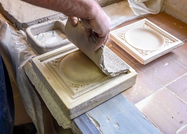 Kacheln in Handarbeit: In der Manufaktur in Baden-Baden wird Ton auf eine Arbeitsform gelegt.