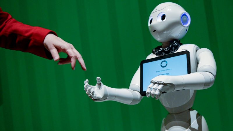 Ein Roboter interagiert bei der Veranstaltung im Hammerbrooklyn Digital Campus in Hamburg mit einer Frau.