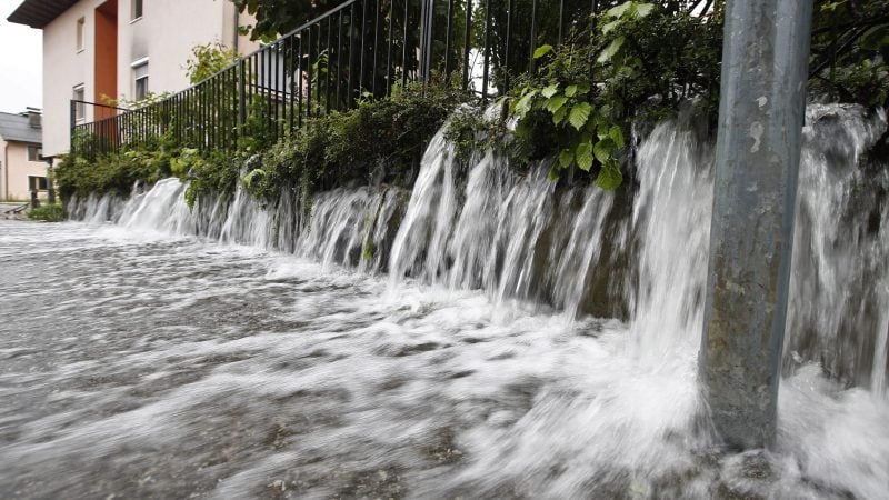 Wasser strömt auf eine Straße in Viktring bei Klagenfurt in Kärnten.