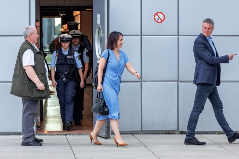 Außenministerin Annalena Baerbock (Bündnis90/Grüne) geht nach ihrer Landung auf dem Flughafen Hamburg hinter einem Sicherheitsbeamten zu ihrem Fahrzeug.