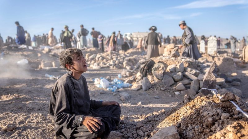 Ein Junge trauert neben dem Grab seines kleinen Bruders, der in der Provinz Herat im Westen Afghanistans ums Leben gekommen ist.