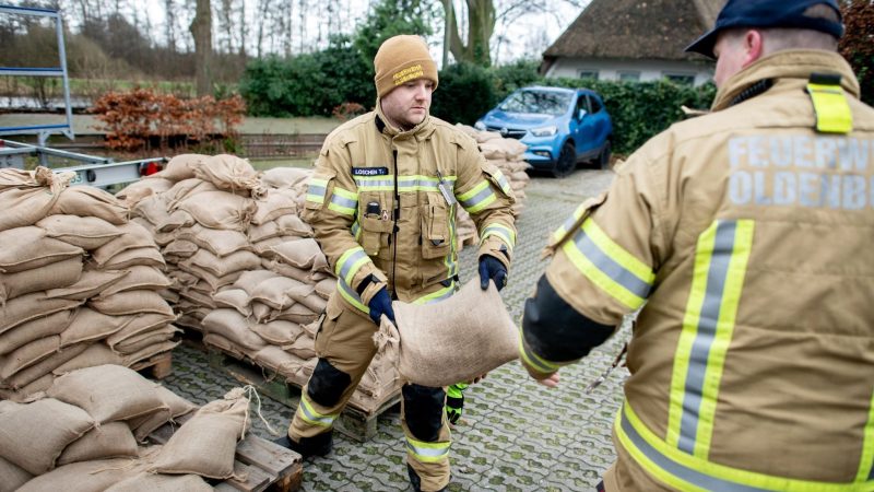 Einsatzkräfte der Feuerwehr geben auf einem Parkplatz in Oldenburg zahlreiche Sandsäcke an die Anwohner im Bereich der Hunte am Achterdiek aus. Die Hochwasserlage bleibt in vielen Regionen Niedersachsens angespannt.