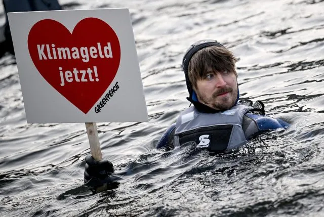 Aktivisten von Verdi, AWO, dem Paritätischen und Greenpeace paddeln in der Spree. Demonstriert wird für eine schnelle Einführung des Klimagelds.