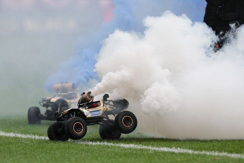 Aus Protest gegen den geplanten Investorendeal der Deutschen Fußball Liga haben Fans des FC Hansa Rostock ferngesteuerte Auto mit blau-weißen Rauchfackeln auf den Platz fahren lassen.