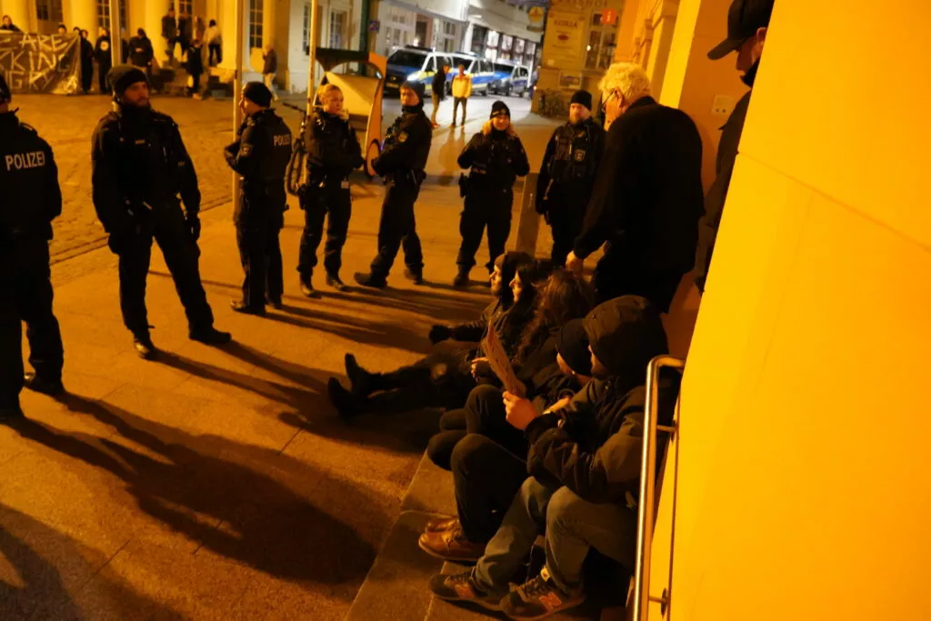 Demonstranten blockieren den Eingang des Rathauses in Schwerin