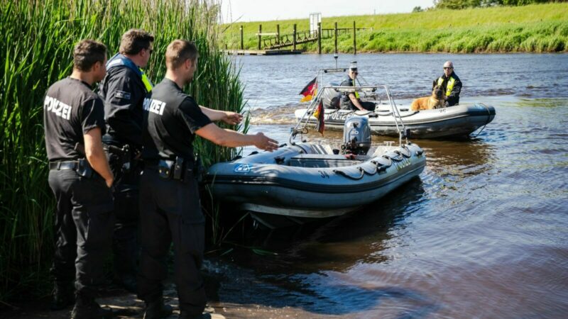 Einsatzkräfte der Polizei fahren bei der Suche nach dem vermissten Arian mit Spürhunden auf Schlauchbooten über die Oste.