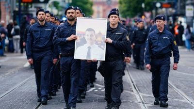 In Gedenken an ihren tödlich verletzten Kollegen Rouven Laur ziehen Polizisten durch die Mannheimer Innenstadt.