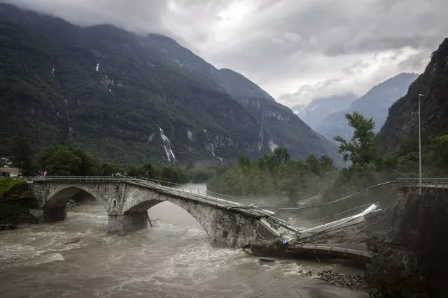 Eine Brücke im Maggiatal wird durch einen reißenden Fluss zerstört.