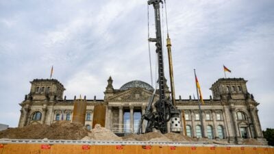 The Reichstag building, which houses Germany's Bundestag lower House of parliament, is obscured by mounds of dirt and excavation equipment, in Berlin on August 22, 2023. Though the current construction involves the installation of underground cables, the German government is planning to dig a 10-meter-wide moat, over two-meters deep, that will run parallel to the building's western facade, in order to enhance the parliament's security. Work is expected to start in 2025. (Photo by John MACDOUGALL / AFP) (Photo by JOHN MACDOUGALL/AFP via Getty Images)