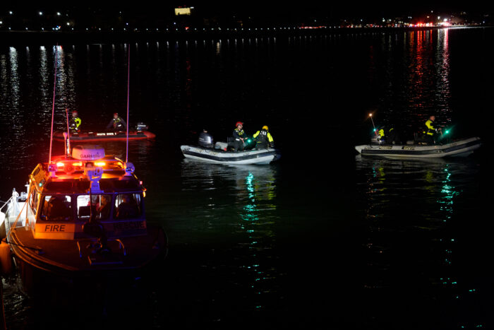 ARLINGTON, VIRGINIA - JANUARY 30: An emergency response team with Washington, DC Fire and EMS make their way to airplane wreckage in the Potomac River near Ronald Reagan Washington Airport on January 30, 2025 in Arlington, Virginia. An American Airlines flight from Wichita, Kansas collided with a helicopter while approaching Ronald Reagan National Airport. (Photo by Andrew Harnik/Getty Images)