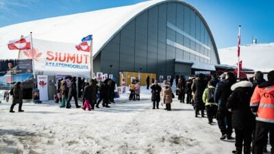 Voters stand in line to cast their ballots for the parliament election at a polling station in Greenland's capital Nuuk, on April 6, 2021. - The autonomous Danish territory of Greenland votes Tuesday in legislative elections, after a campaign focused on a disputed mining project, as the Arctic island confronts first-hand the effects of global warming. - Denmark OUT (Photo by Emil Helms / Ritzau Scanpix / AFP) / Denmark OUT (Photo by EMIL HELMS/Ritzau Scanpix/AFP via Getty Images)