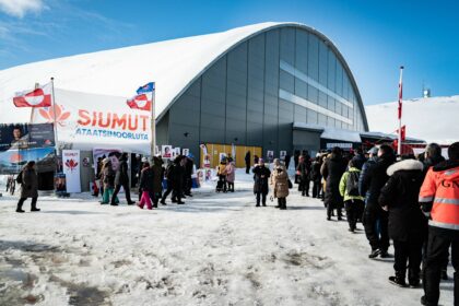 Voters stand in line to cast their ballots for the parliament election at a polling station in Greenland's capital Nuuk, on April 6, 2021. - The autonomous Danish territory of Greenland votes Tuesday in legislative elections, after a campaign focused on a disputed mining project, as the Arctic island confronts first-hand the effects of global warming. - Denmark OUT (Photo by Emil Helms / Ritzau Scanpix / AFP) / Denmark OUT (Photo by EMIL HELMS/Ritzau Scanpix/AFP via Getty Images)