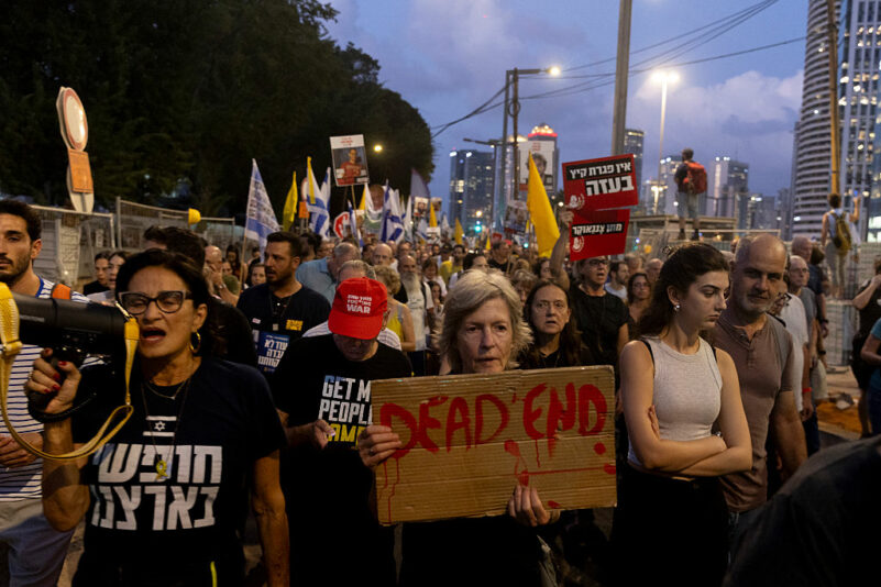 TEL AVIV, ISRAEL - AUGUST 26: Protesters march during a rally calling for the Israeli government to sign a deal to release the hostages held in the Gaza Strip, on August 26, 2025 in Tel Aviv, Israel. The protesters renewed their call for a ceasefire in Gaza and an end to the war, in hopes of bringing remaining hostages home. (Photo by Amir Levy/Getty Images)