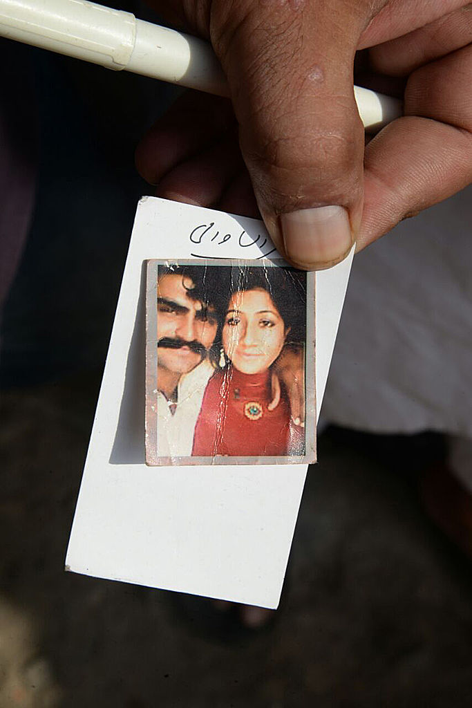 A Pakistani man displays a photograph of his wife Muqaddas Bibi, who was killed by her relatives in a so-called 'honour killing' in the village of Buttaranwali, some 75 kilometres north of Punjab provincial capital Lahore, on June 17, 2016. Relatives slit the throat of a young mother who was pregnant with her second child after she married against their will in eastern Pakistan, officials said on June 17, the latest in a spate of so-called "honour killings". / AFP / KHURRAM BUTT (Photo credit should read KHURRAM BUTT/AFP via Getty Images)