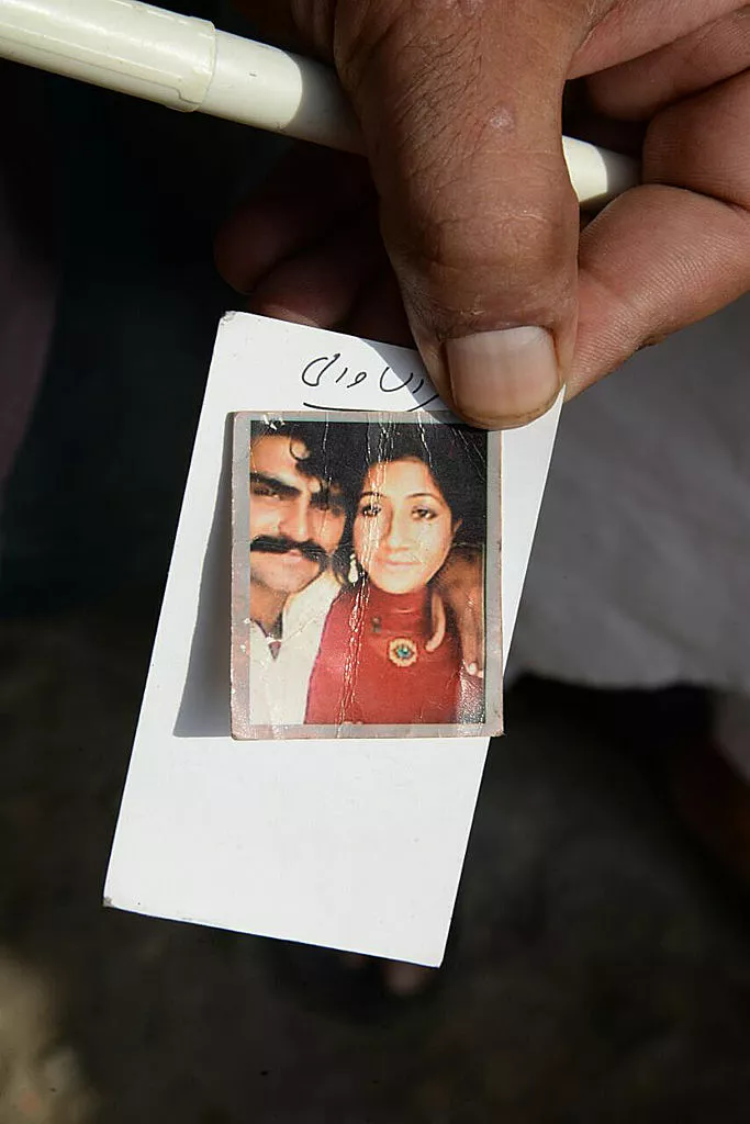 A Pakistani man displays a photograph of his wife Muqaddas Bibi, who was killed by her relatives in a so-called 'honour killing' in the village of Buttaranwali, some 75 kilometres north of Punjab provincial capital Lahore, on June 17, 2016. Relatives slit the throat of a young mother who was pregnant with her second child after she married against their will in eastern Pakistan, officials said on June 17, the latest in a spate of so-called &quot;honour killings&quot;. / AFP / KHURRAM BUTT (Photo credit should read KHURRAM BUTT/AFP via Getty Images)